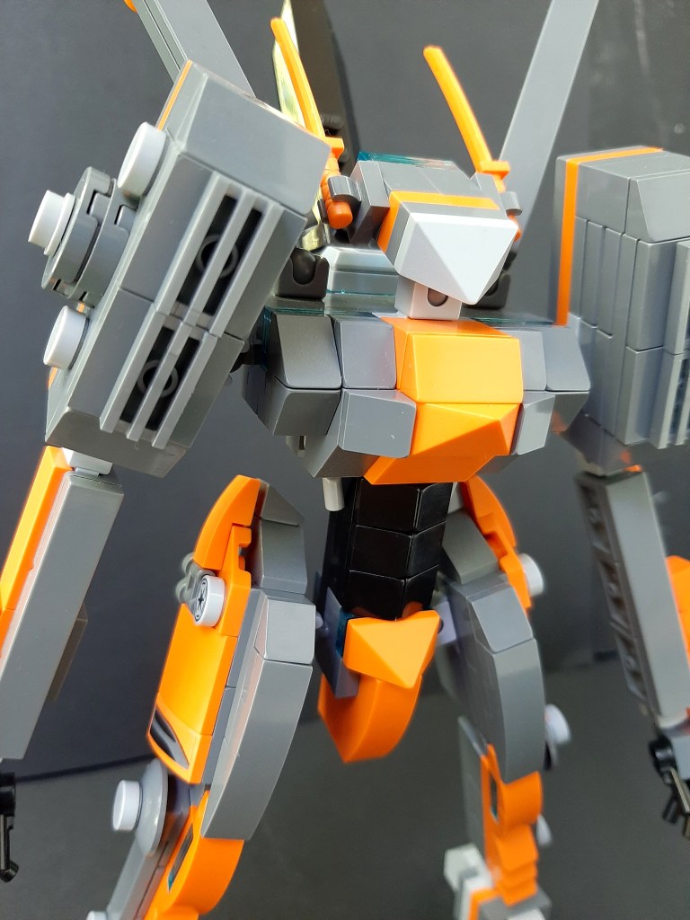 close up of orange and gray lego mech